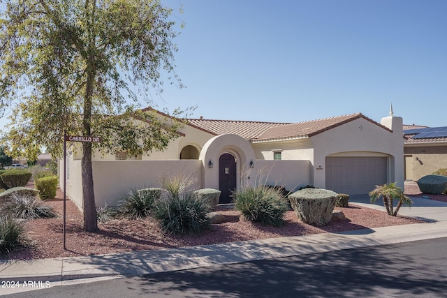 mediterranean / spanish house featuring a garage