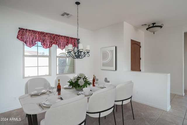 tiled dining space featuring a notable chandelier