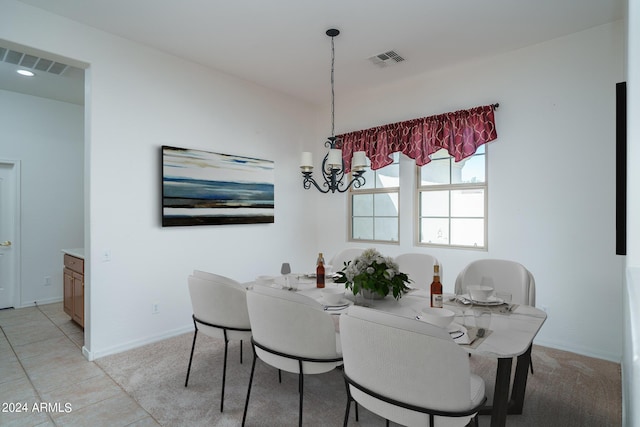 tiled dining space featuring an inviting chandelier