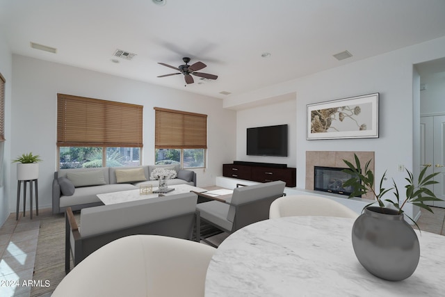 living room with ceiling fan and a fireplace