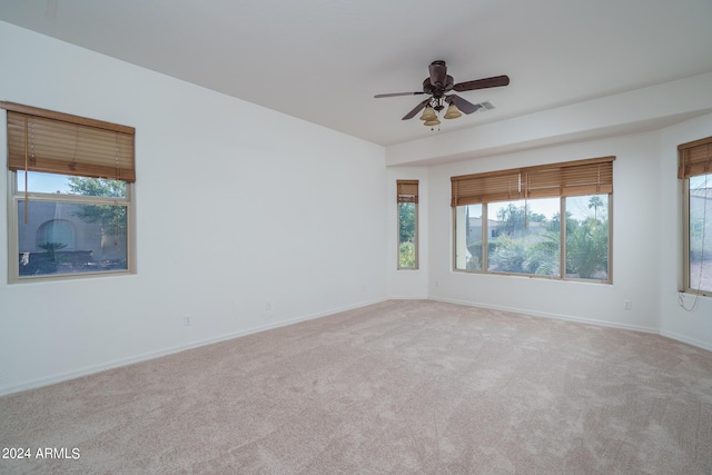 carpeted empty room featuring ceiling fan