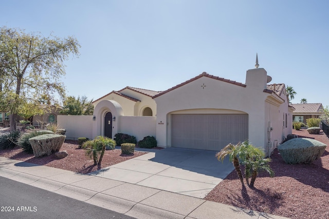 mediterranean / spanish home featuring a garage