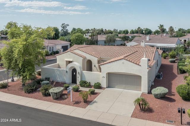 mediterranean / spanish house featuring a garage