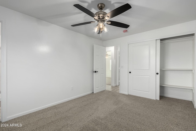 unfurnished bedroom with light carpet, ceiling fan, and a closet