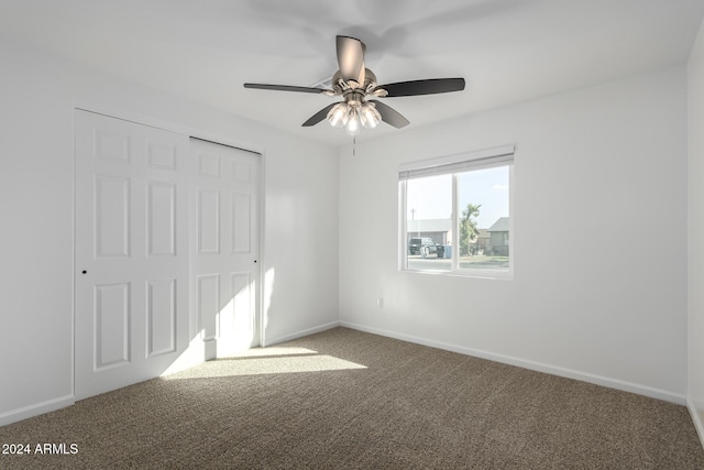 carpeted empty room featuring ceiling fan