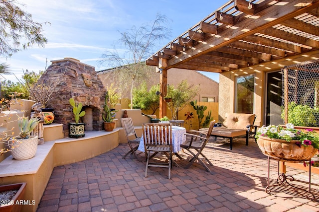 view of patio / terrace featuring a pergola and an outdoor stone fireplace