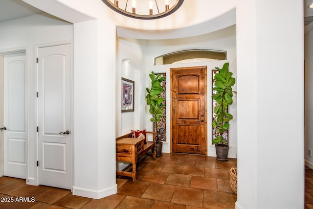 foyer entrance with a chandelier