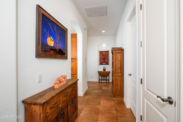 hall with light tile patterned floors