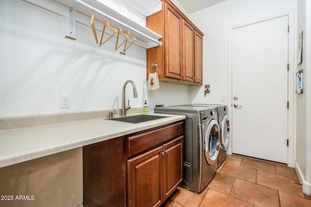 washroom featuring cabinets, washing machine and dryer, sink, and light tile patterned floors