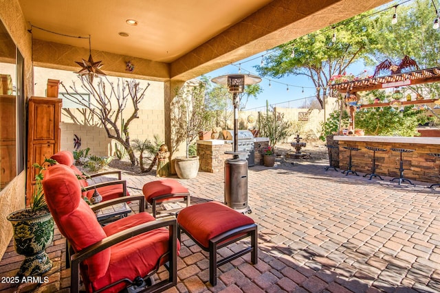 view of patio / terrace featuring an outdoor kitchen and a grill