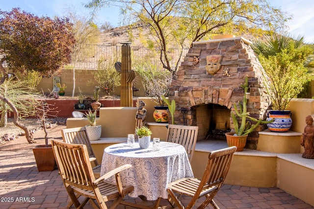 view of patio featuring an outdoor stone fireplace