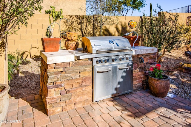 view of patio with exterior kitchen and area for grilling