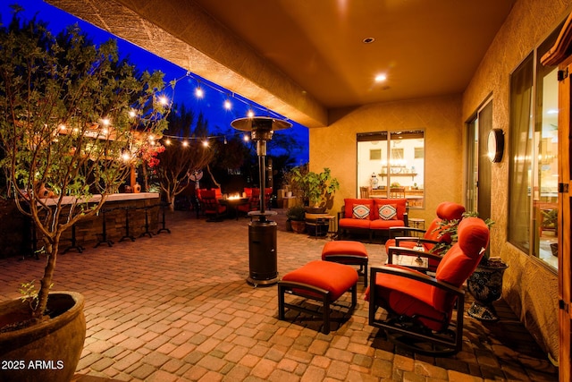 patio at night featuring an outdoor living space