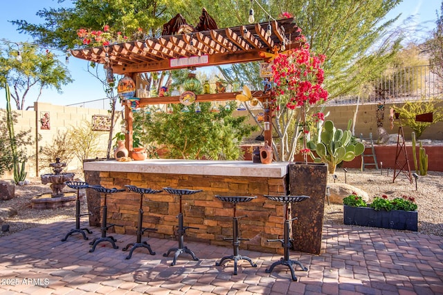 view of patio featuring an outdoor bar