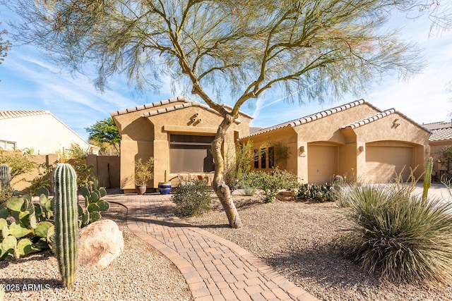 mediterranean / spanish-style home featuring a garage