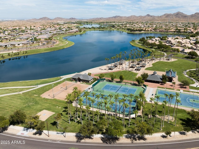 drone / aerial view featuring a water and mountain view