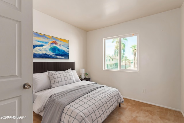 bedroom featuring light carpet