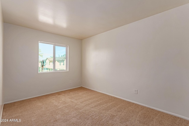 unfurnished room featuring light colored carpet