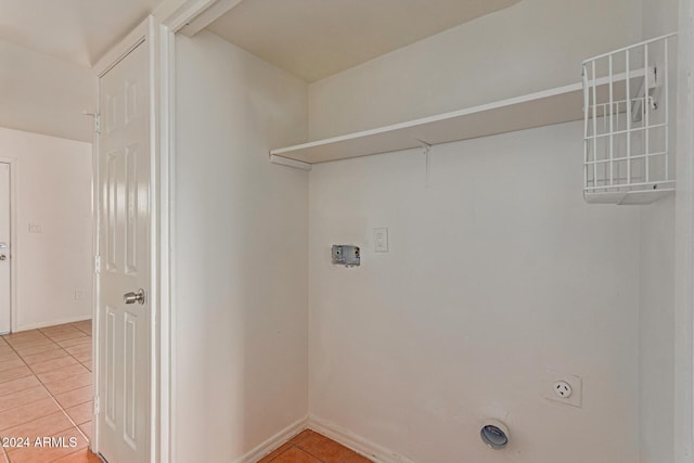 laundry area with hookup for an electric dryer and tile patterned floors