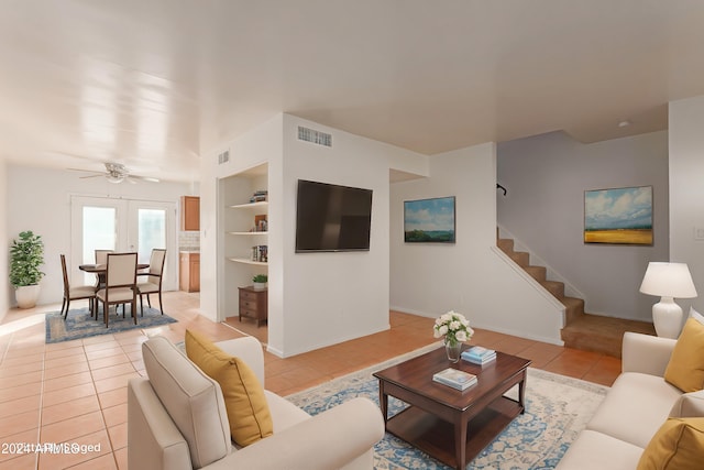 tiled living room featuring built in shelves, ceiling fan, and french doors