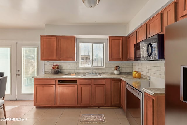 kitchen featuring appliances with stainless steel finishes, tasteful backsplash, a healthy amount of sunlight, and sink