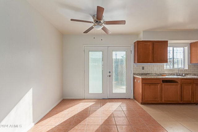 kitchen with backsplash, french doors, sink, ceiling fan, and light tile patterned floors