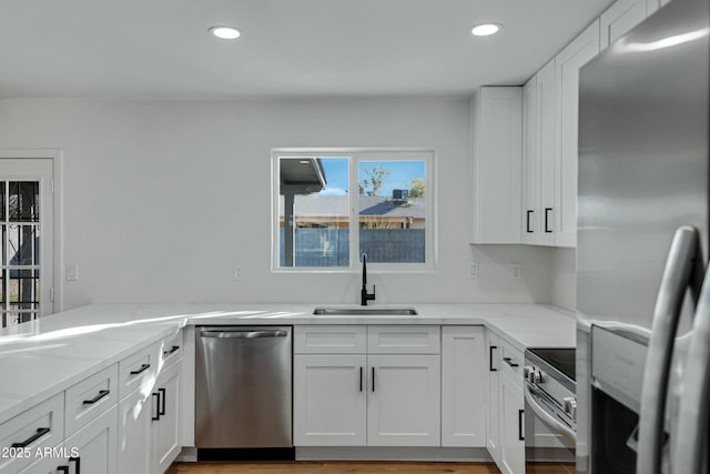 kitchen featuring white cabinetry, appliances with stainless steel finishes, and sink