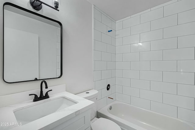 full bathroom featuring vanity, toilet, and tiled shower / bath