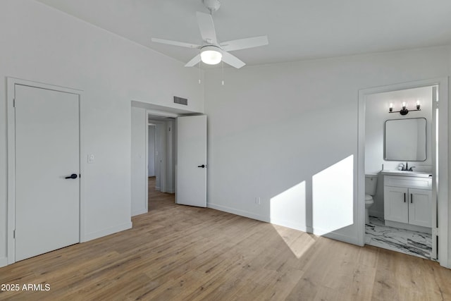 unfurnished bedroom with light hardwood / wood-style flooring, vaulted ceiling, ceiling fan, and ensuite bathroom