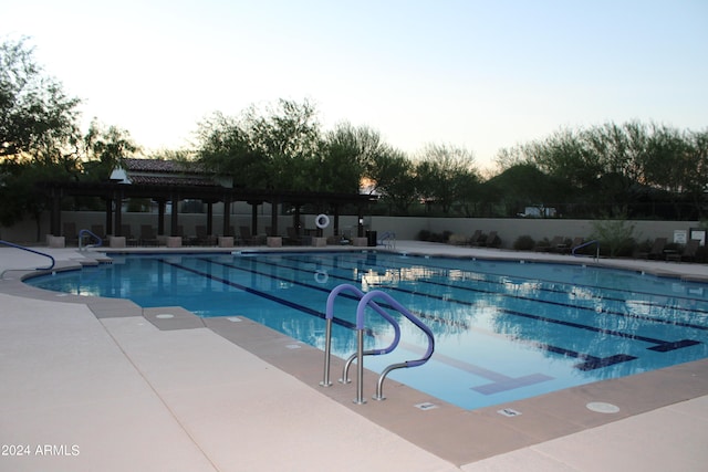 pool at dusk with a patio