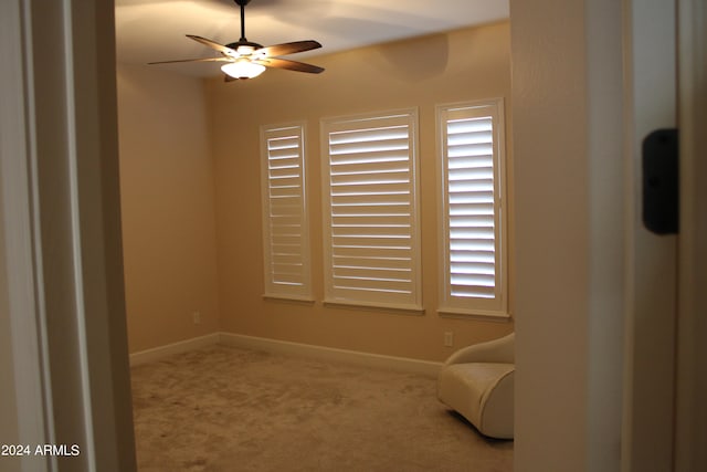 sitting room with carpet and ceiling fan