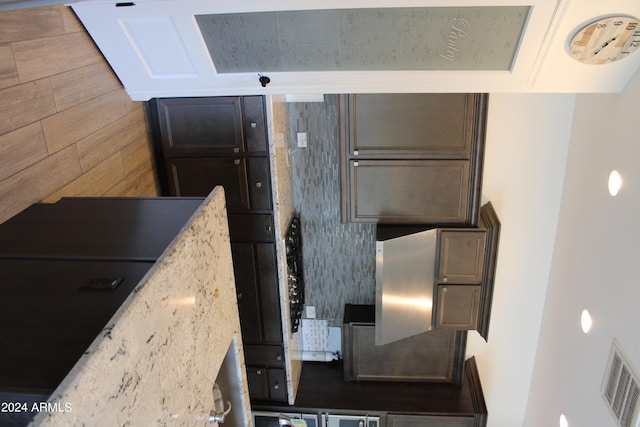 kitchen featuring dark brown cabinetry