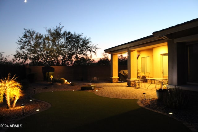 yard at dusk with a patio