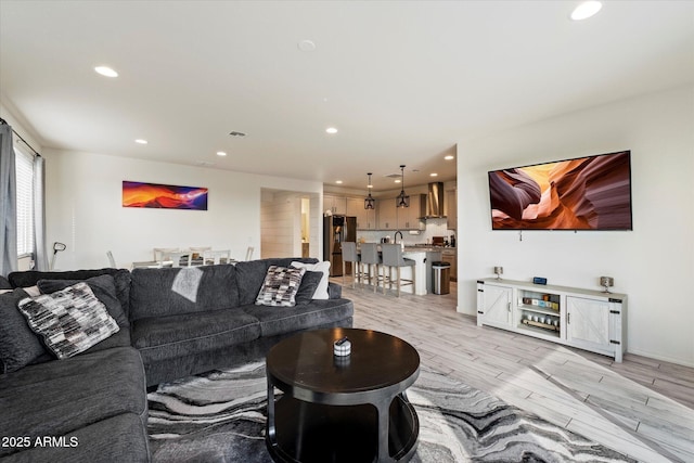 living area featuring recessed lighting and light wood-style floors