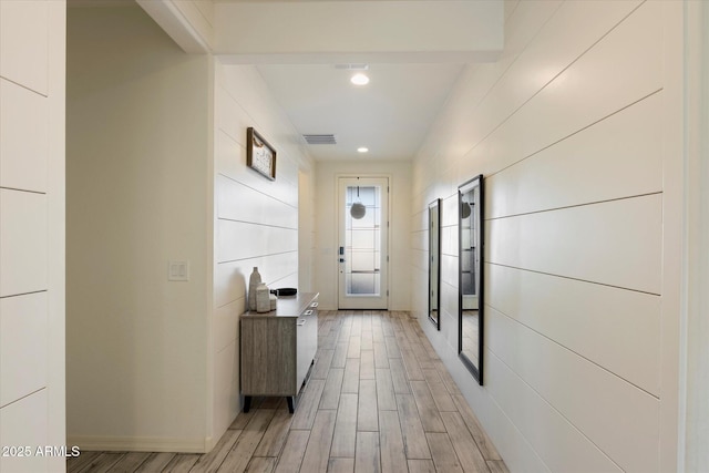 hall featuring visible vents, recessed lighting, and light wood-type flooring