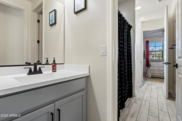 full bath featuring vanity and wood finished floors
