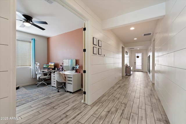 hallway with plenty of natural light, recessed lighting, light wood-style flooring, and visible vents