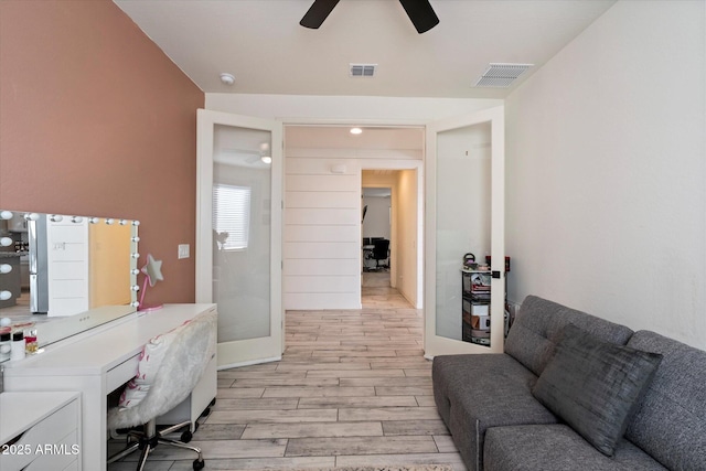 office with visible vents, a ceiling fan, and light wood finished floors