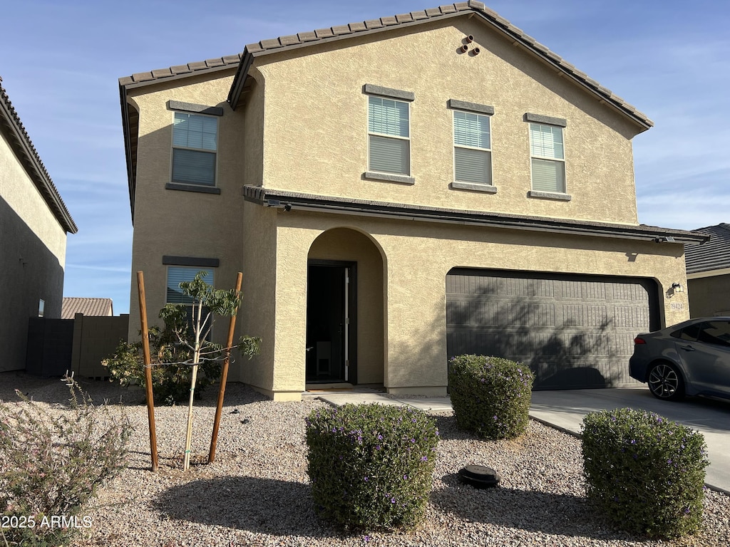 view of front facade featuring stucco siding, a garage, and concrete driveway