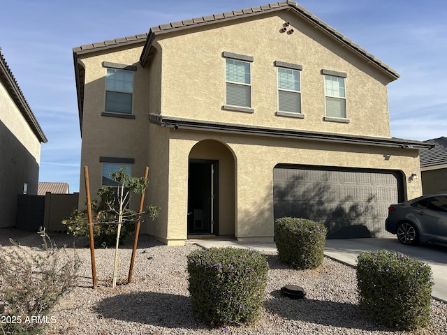 view of front facade featuring stucco siding, a garage, and concrete driveway