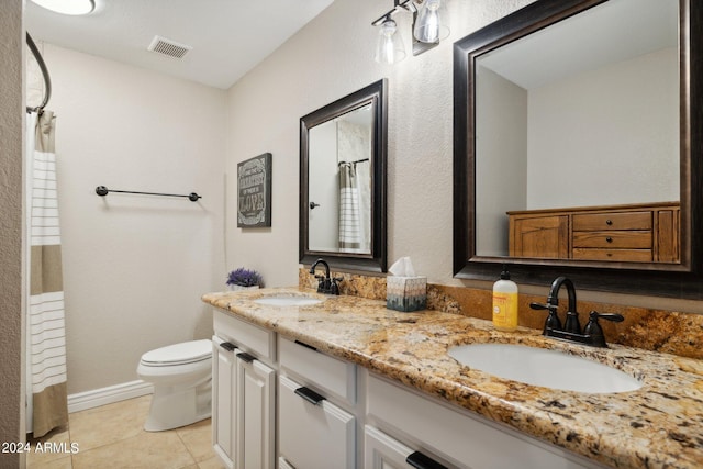 bathroom featuring tile patterned flooring, vanity, and toilet