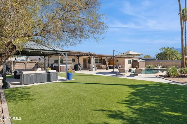 rear view of property with a patio area, a gazebo, a lawn, outdoor lounge area, and a pool with hot tub