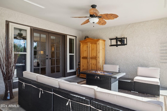 view of patio featuring french doors, ceiling fan, and an outdoor living space with a fire pit