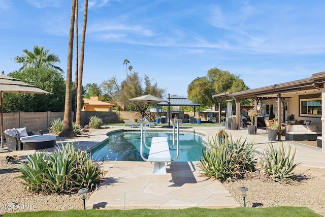 view of pool with a gazebo, an outdoor living space, and a patio