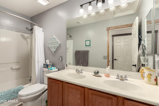 full bathroom with vanity, shower / tub combo, and toilet