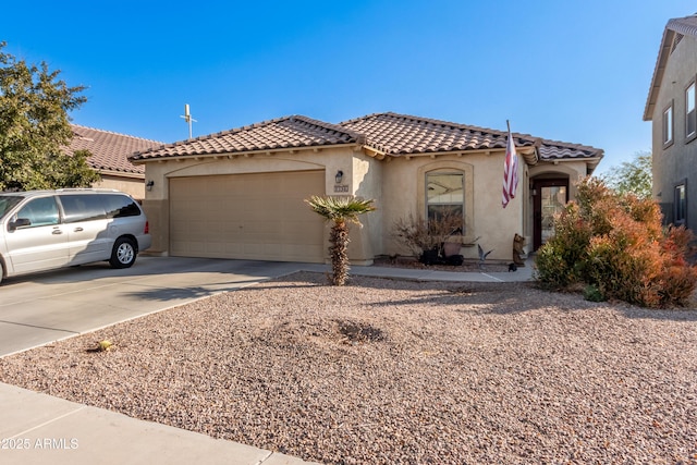 mediterranean / spanish-style home with a garage