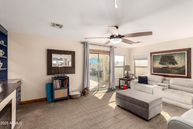 carpeted living room featuring ceiling fan