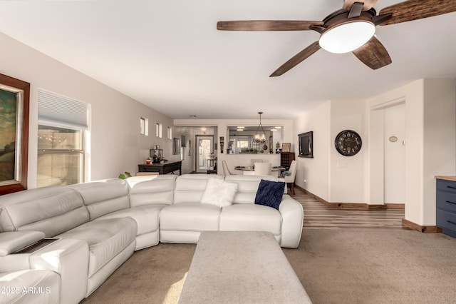 living room with ceiling fan, a healthy amount of sunlight, and carpet flooring