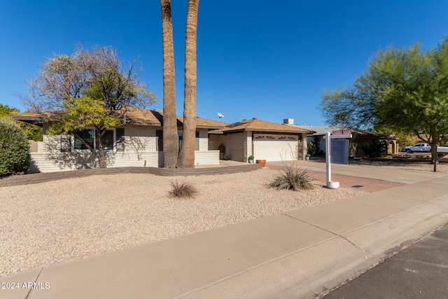 ranch-style home featuring a garage