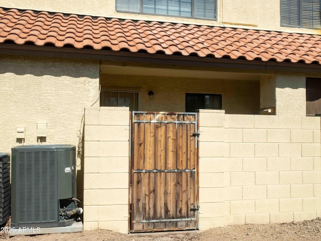 455 S Mesa Dr Unit 104, Mesa, AZ 85210 - property entrance featuring central AC, a gate, and a tile roof